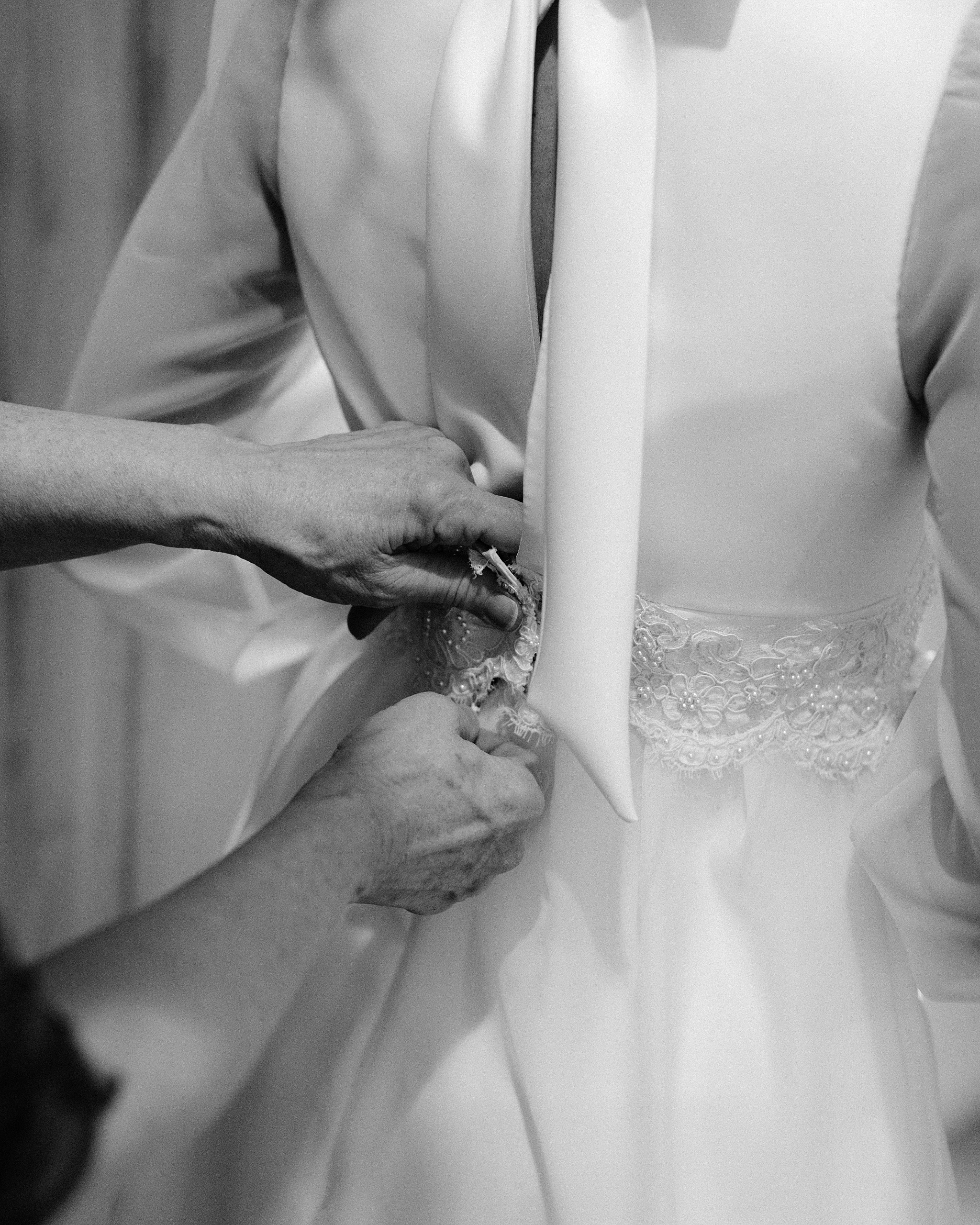 xClose-up of bride’s handmade lace wedding dress, lovingly crafted by her mother, at an intimate desert wedding in Scottsdale.