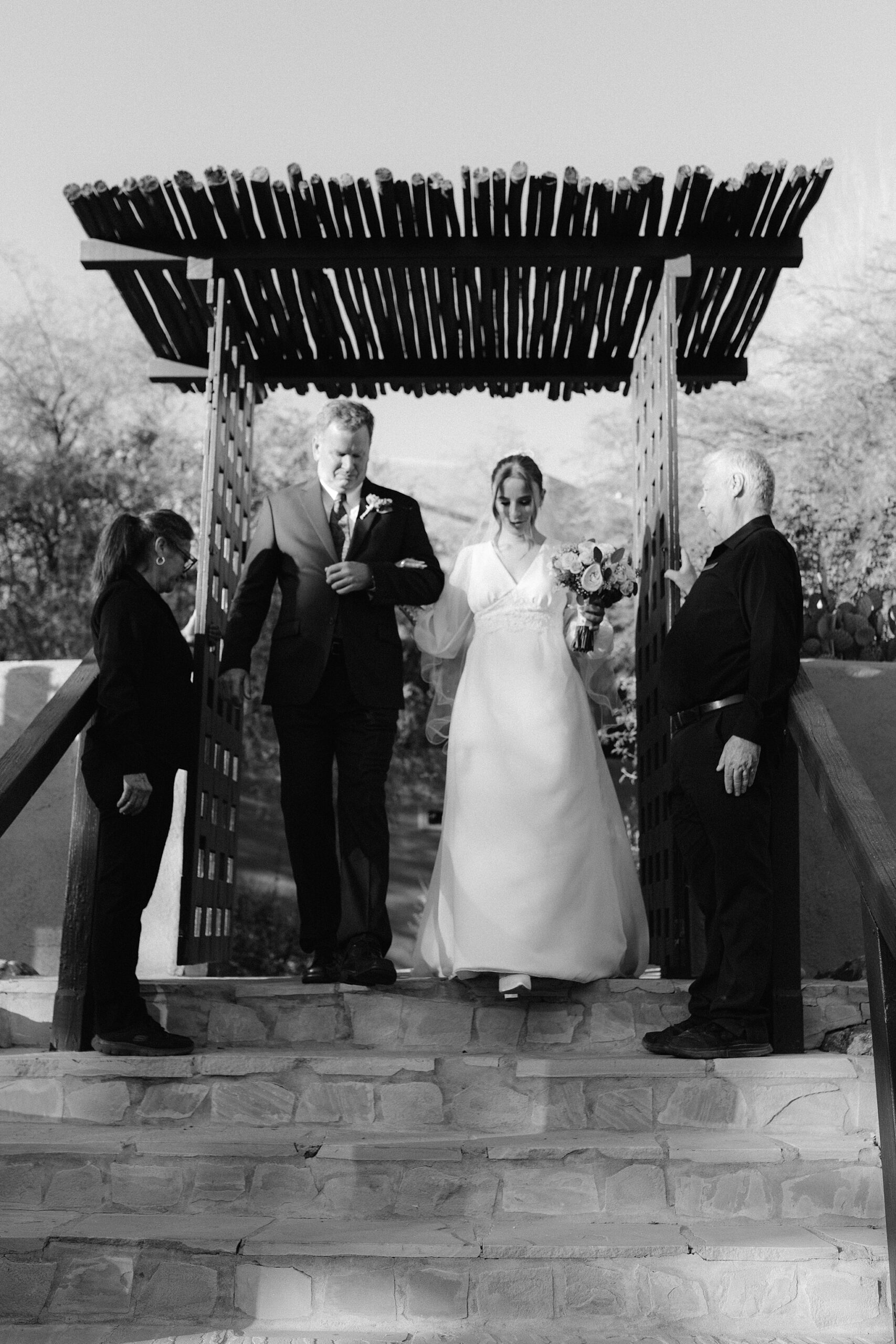Father and Bride walking down the aisle at the Organic Gardens in The Boulders Resort