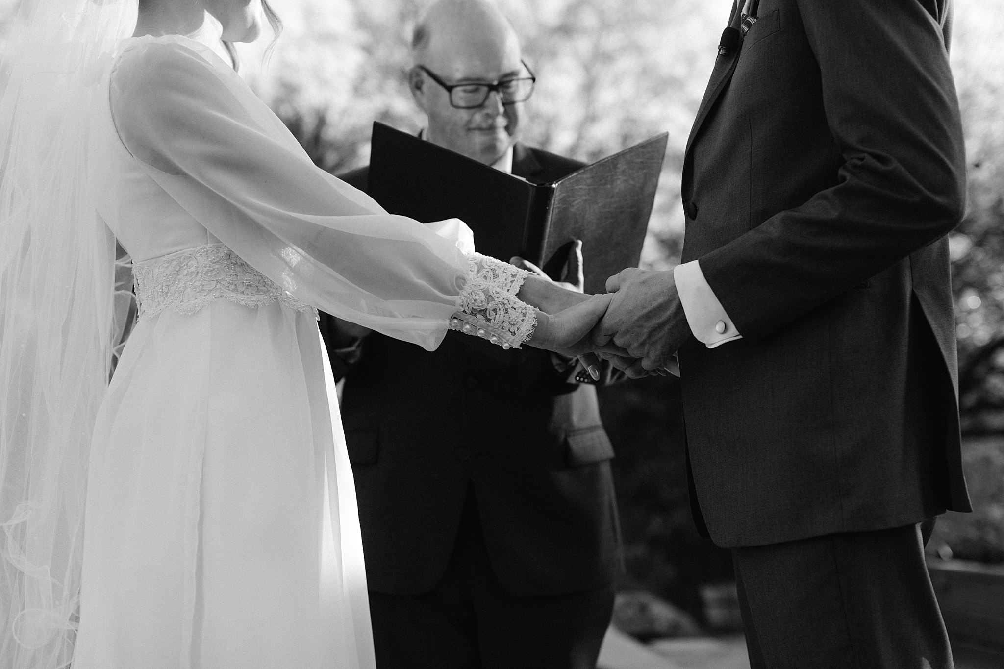 Bride and groom exchanging vows in the organic garden at The Boulders Resort, Scottsdale, with stunning desert scenery in the background.