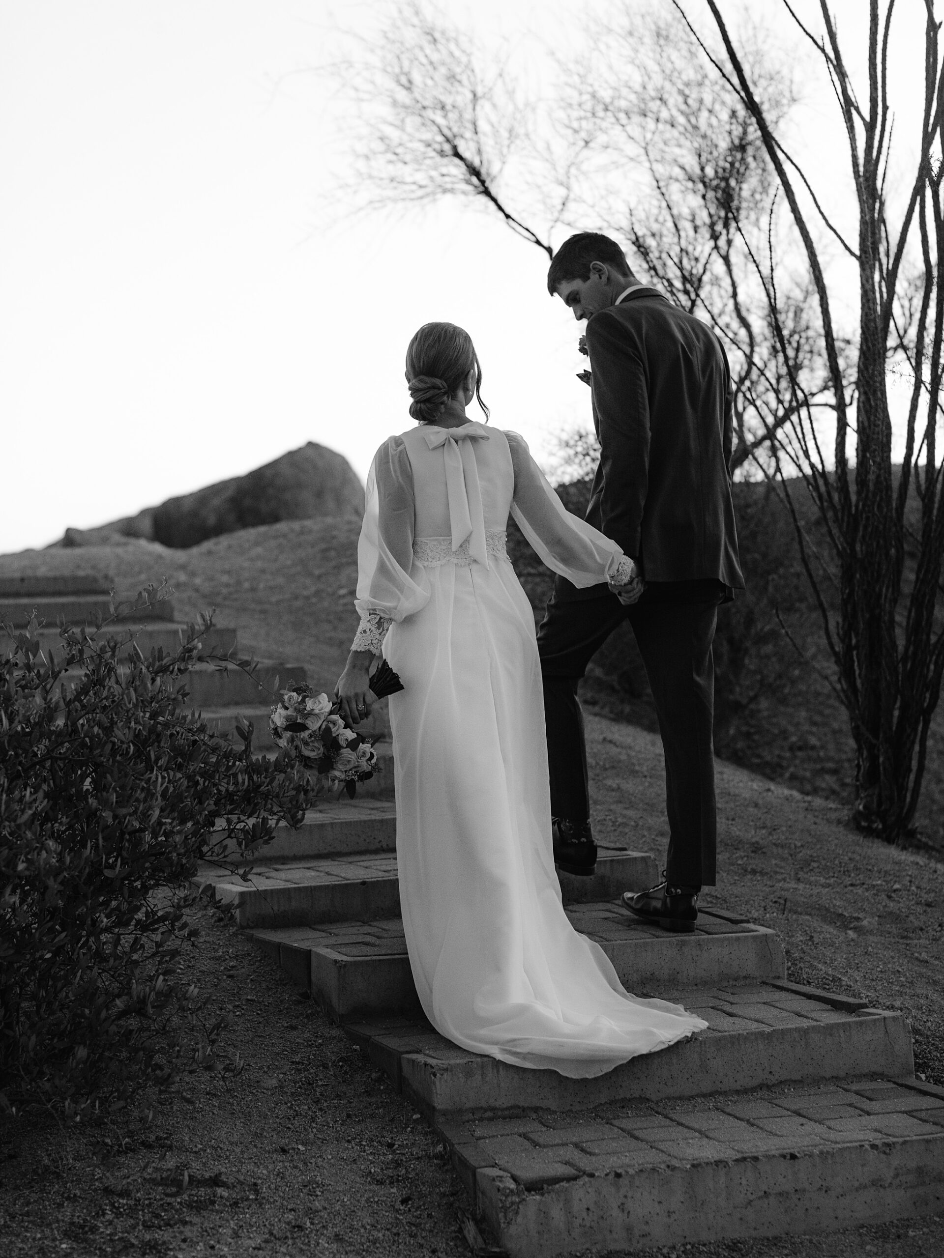 Bride and Groom holding hands at the Boulders Resort