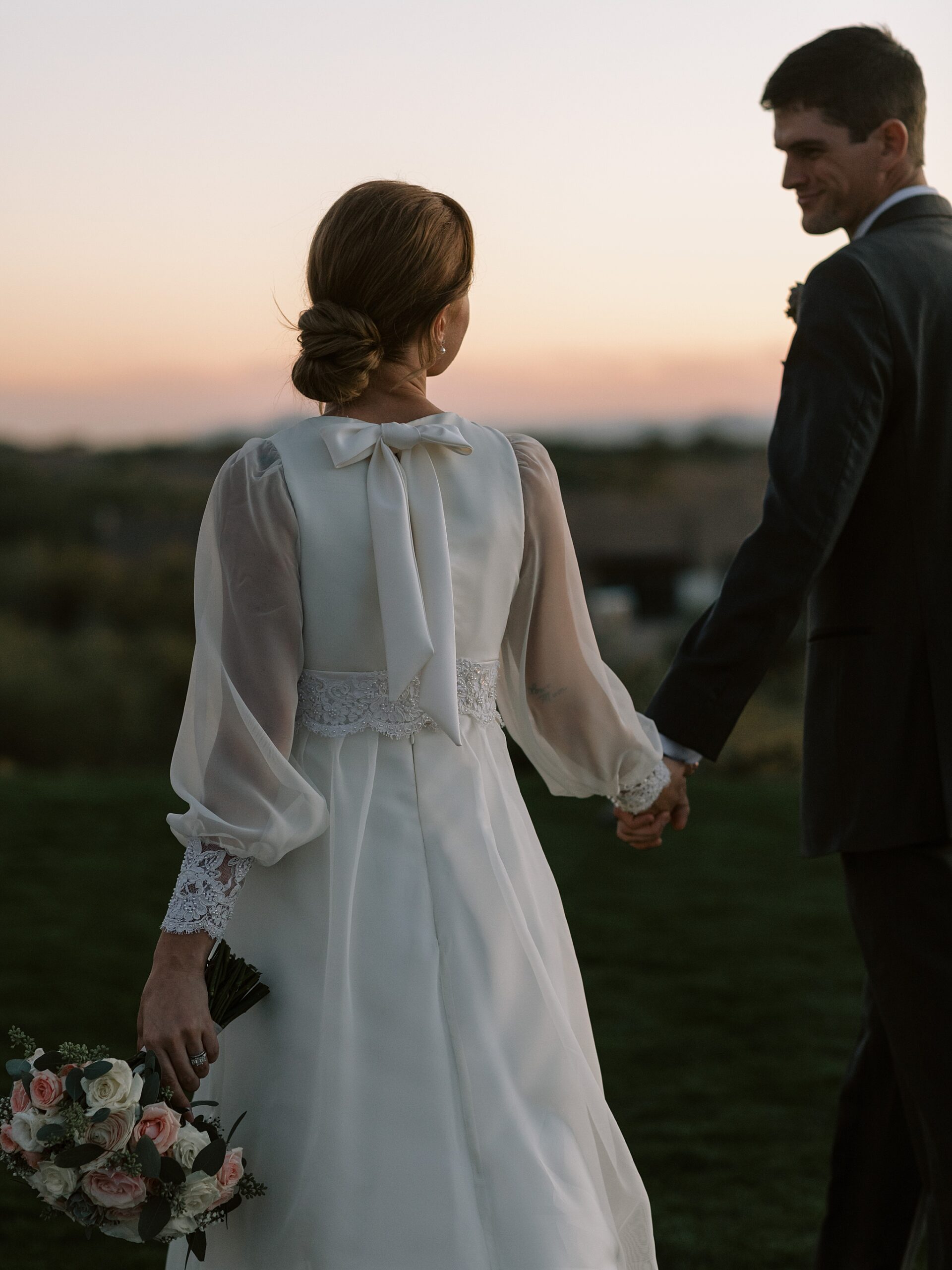 Bride and Groom holding hands at the Boulders Resort