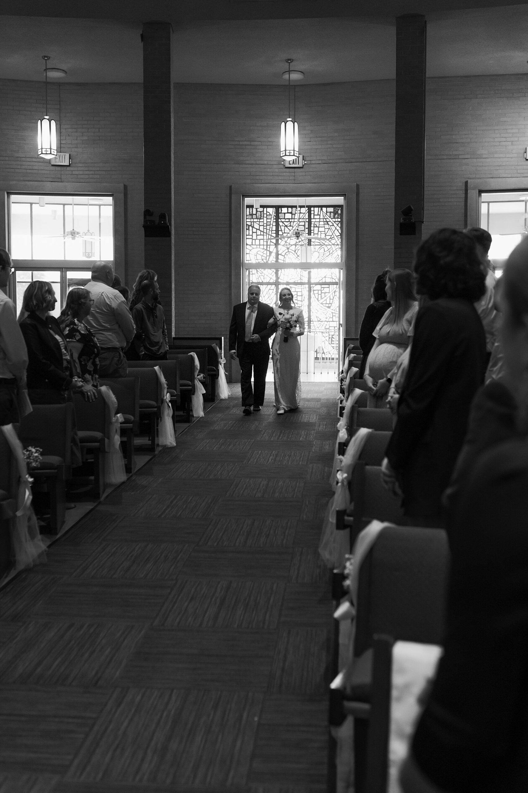 Allison and Kevin exchange vows in a traditional Catholic ceremony at Our Lady of Mount Carmel Catholic Church