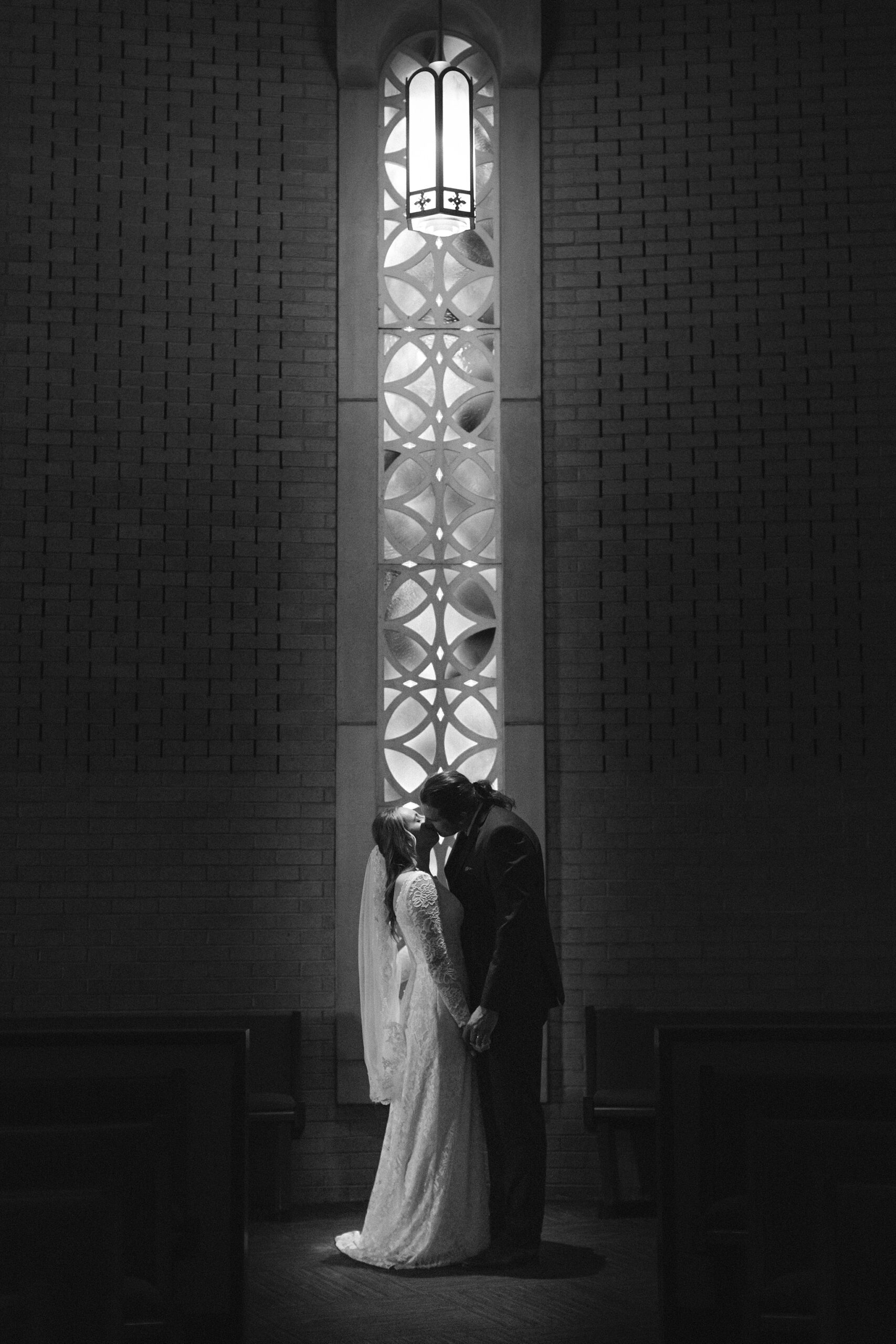 Elegant portrait of Allison in her wedding gown at Our Lady of Mount Carmel during a traditional Catholic ceremony.