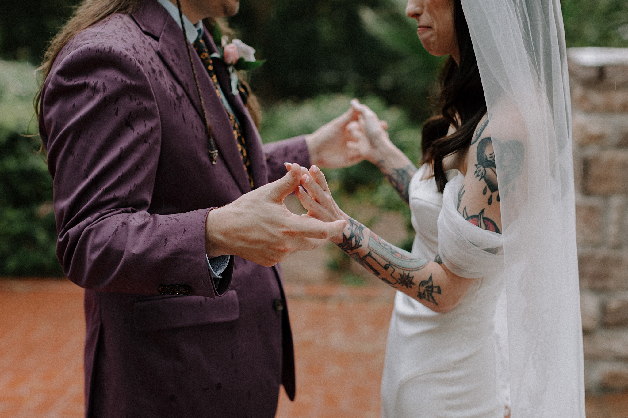 Bride and grooms first look under the trees in light rain