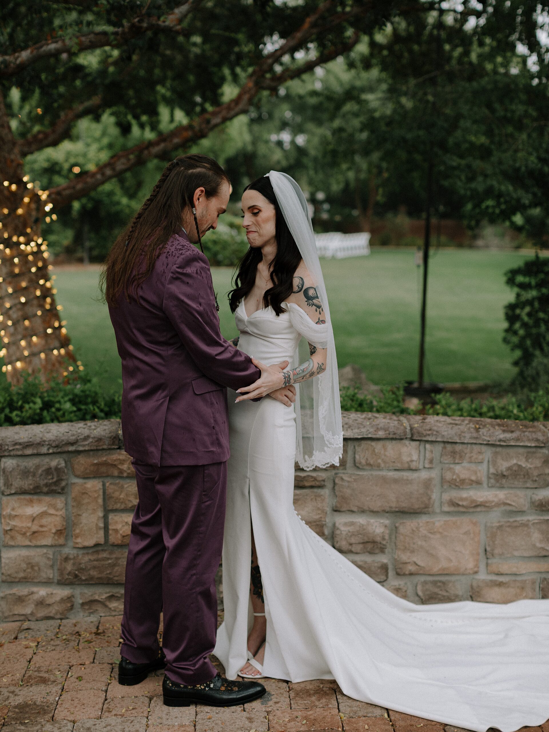 Bride and grooms first look under the trees in light rain