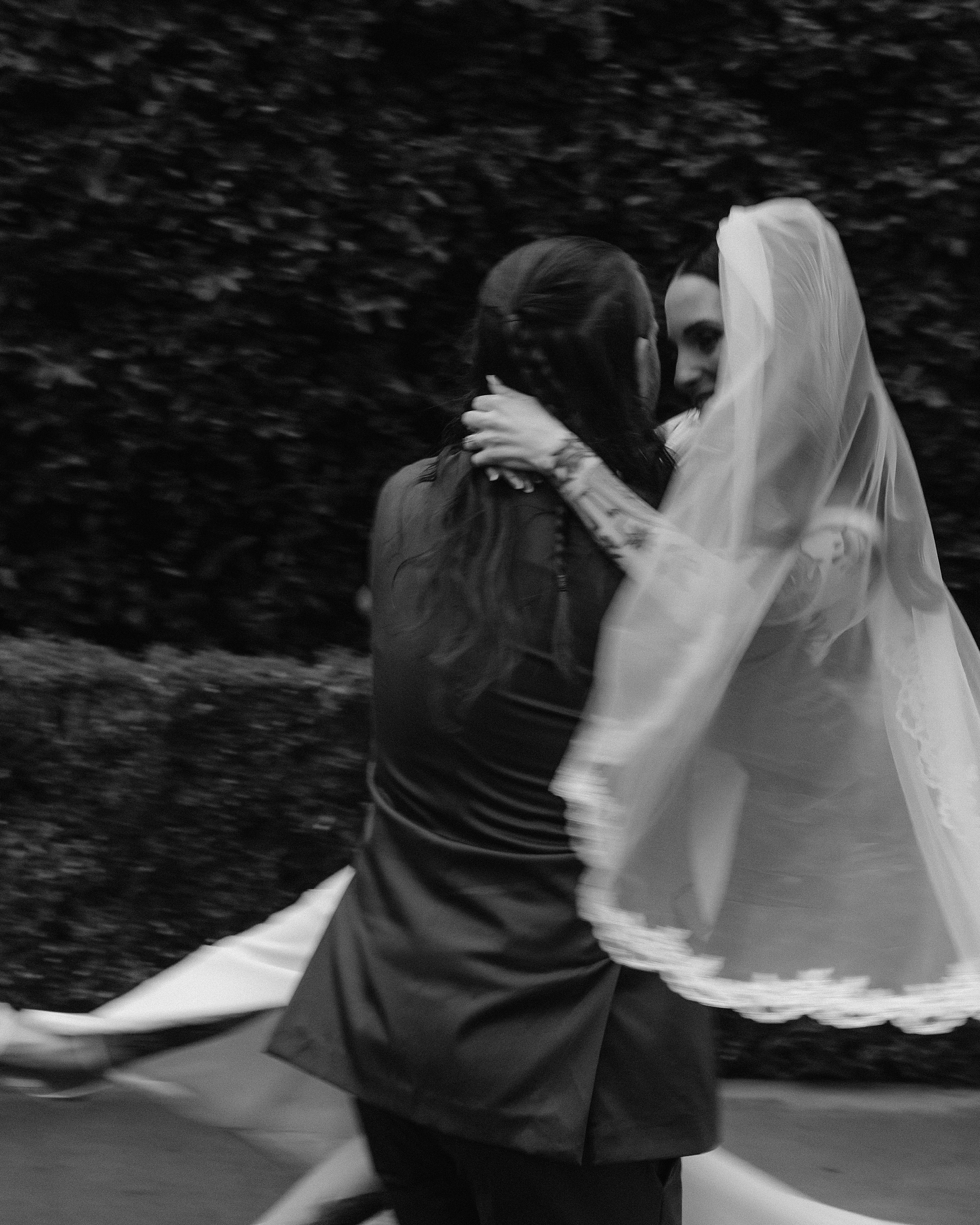 Bride and groom laughing together after the ceremony in the rain