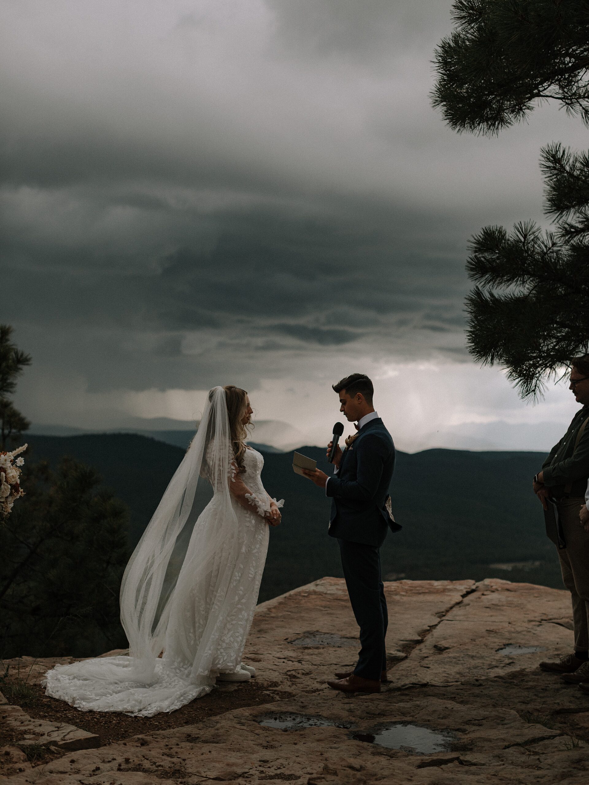 Bride and groom exchanging vows in the rain during Mogollon Rim wedding