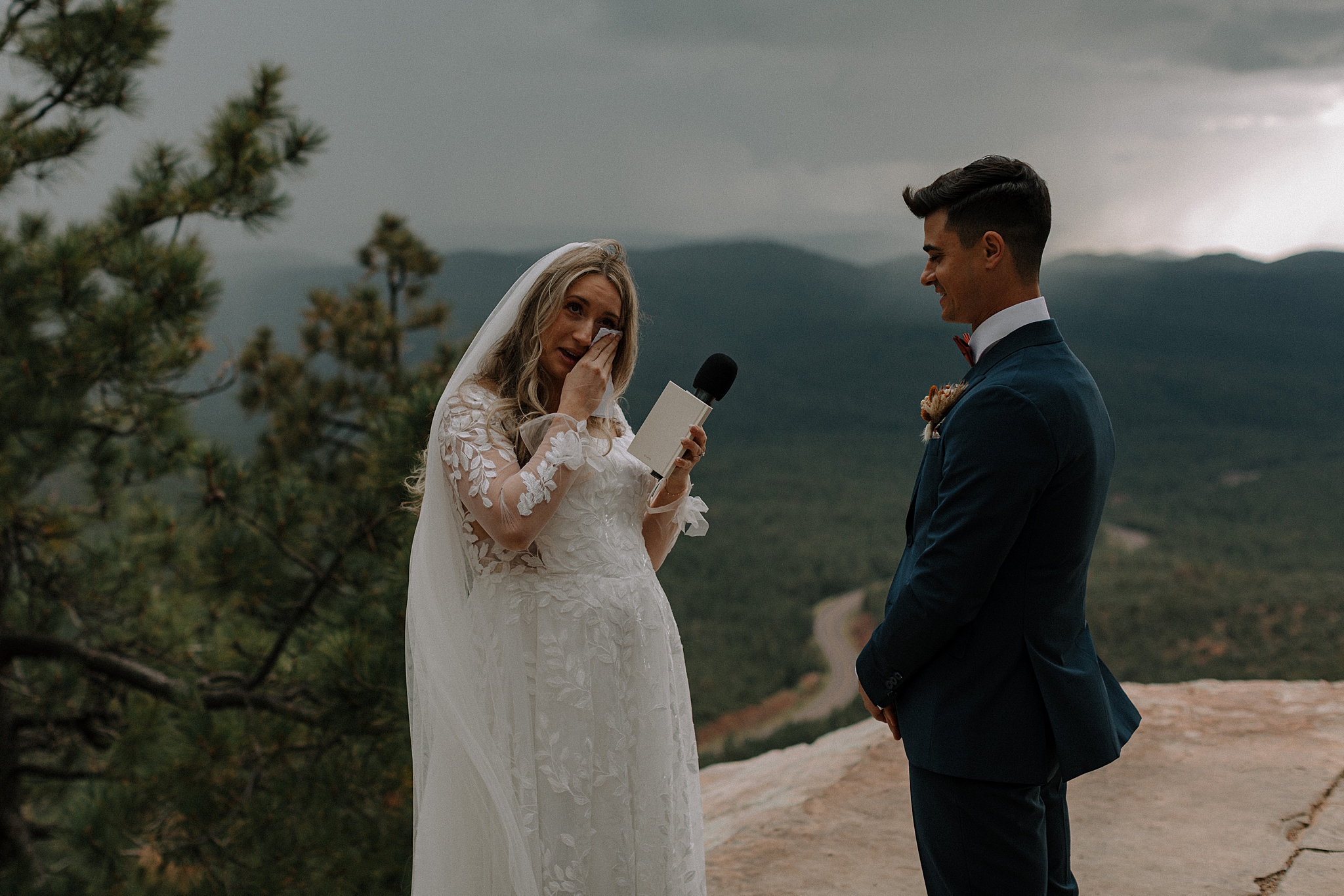 Bride and groom exchanging vows in the rain during Mogollon Rim wedding