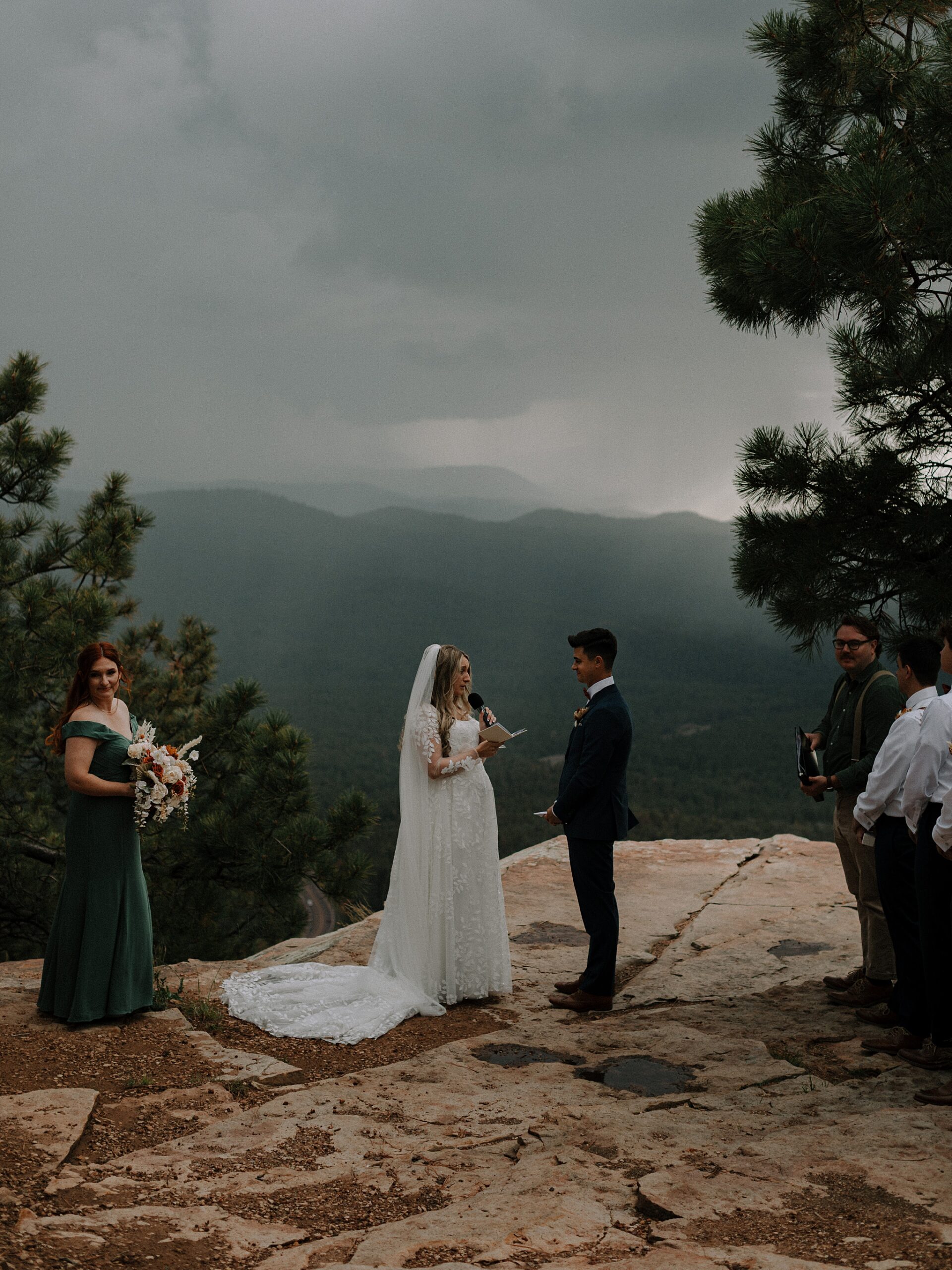 Bride and groom exchanging vows in the rain during Mogollon Rim wedding