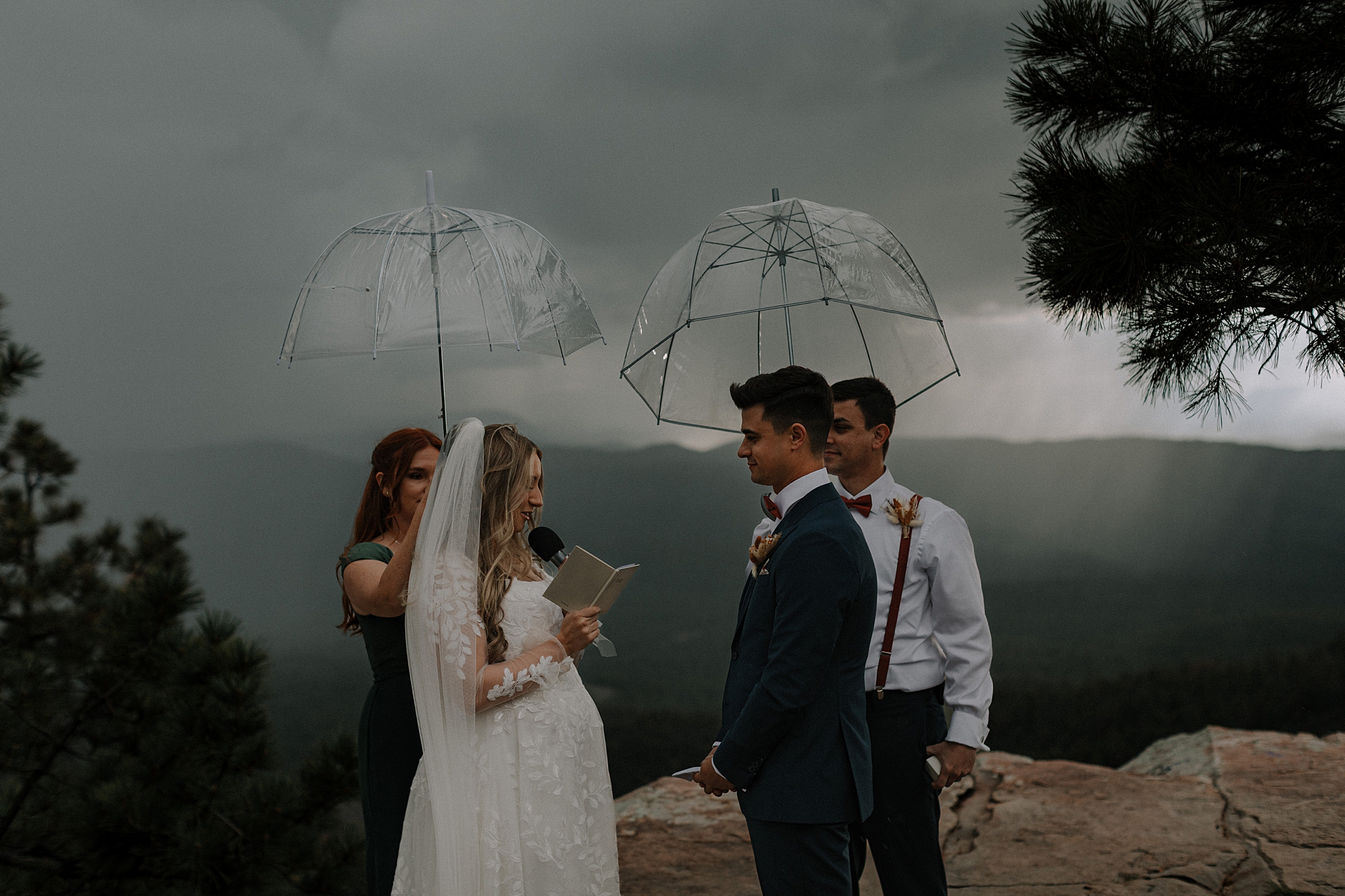 Bride and groom exchanging vows in the rain during Mogollon Rim wedding