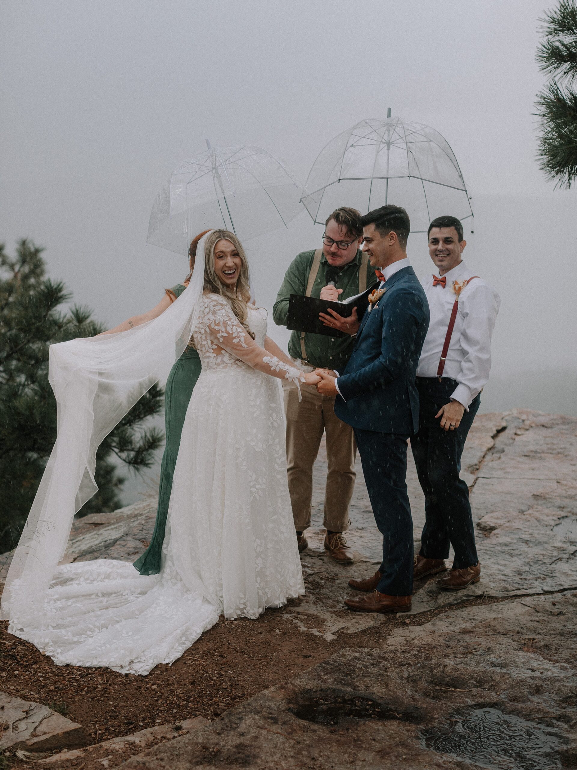 Rainy ceremony with umbrellas at Mogollon Rim overlook