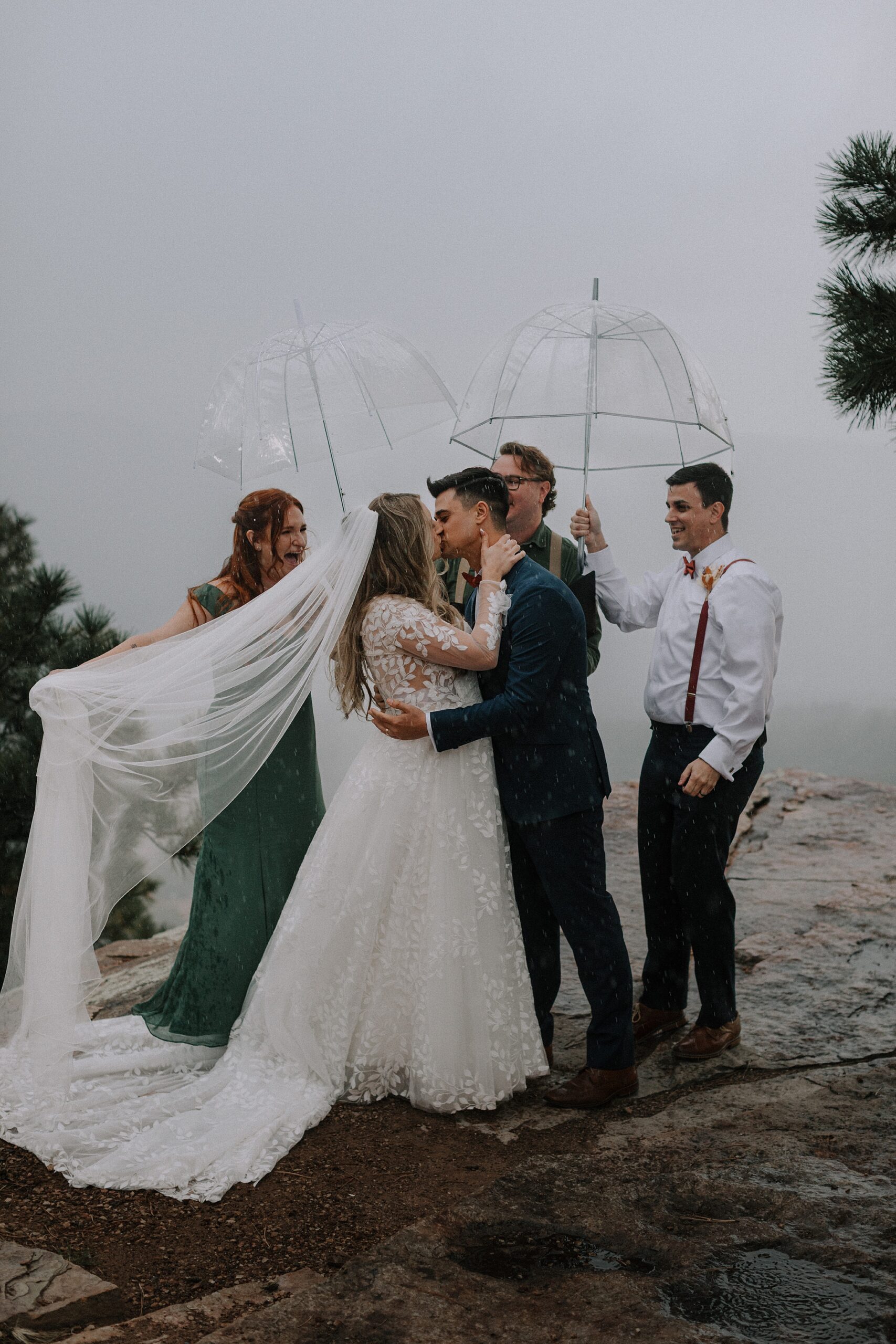 Rainy ceremony with umbrellas at Mogollon Rim overlook