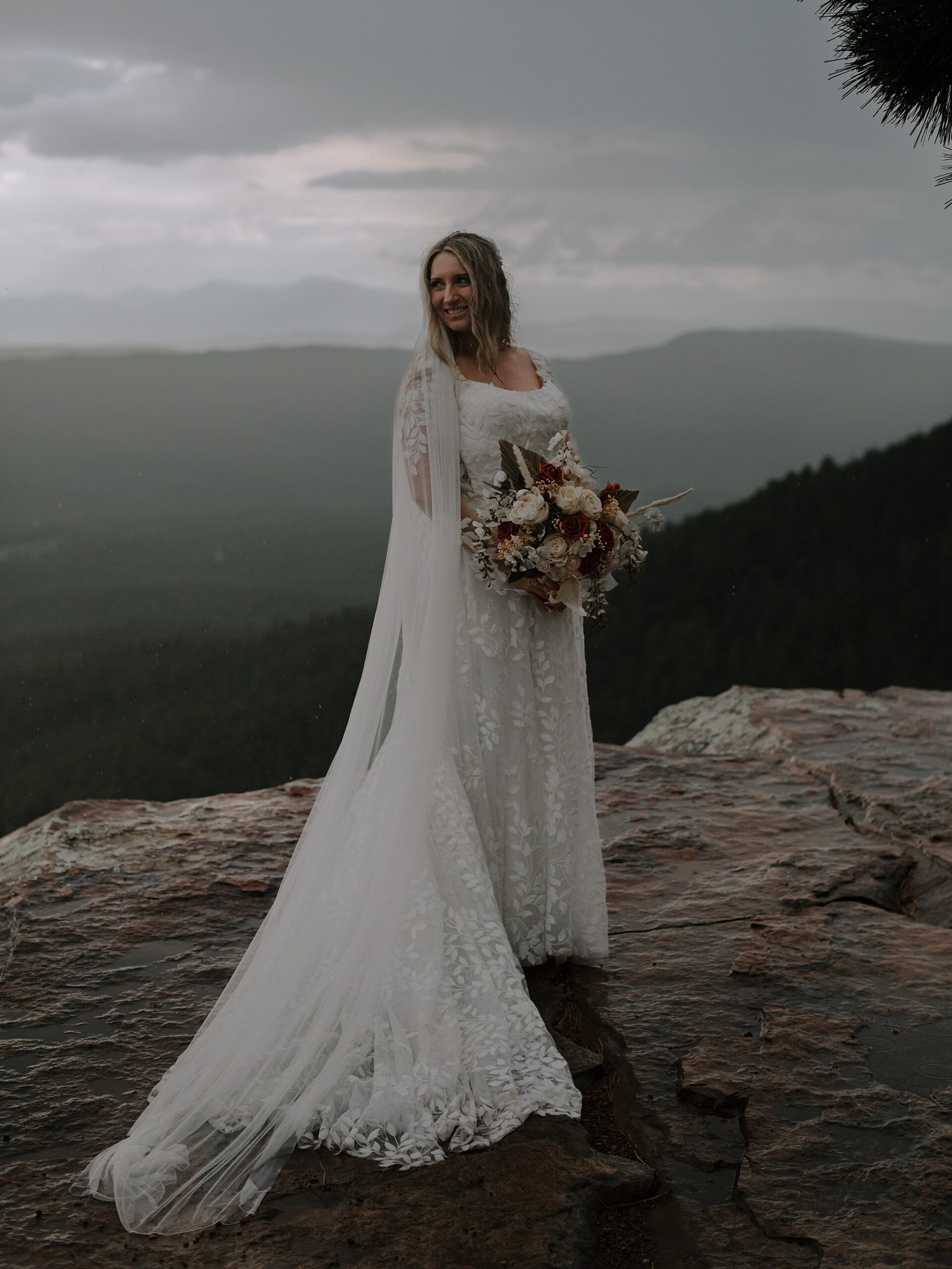 Bride looking out over misty Mogollon Rim forest