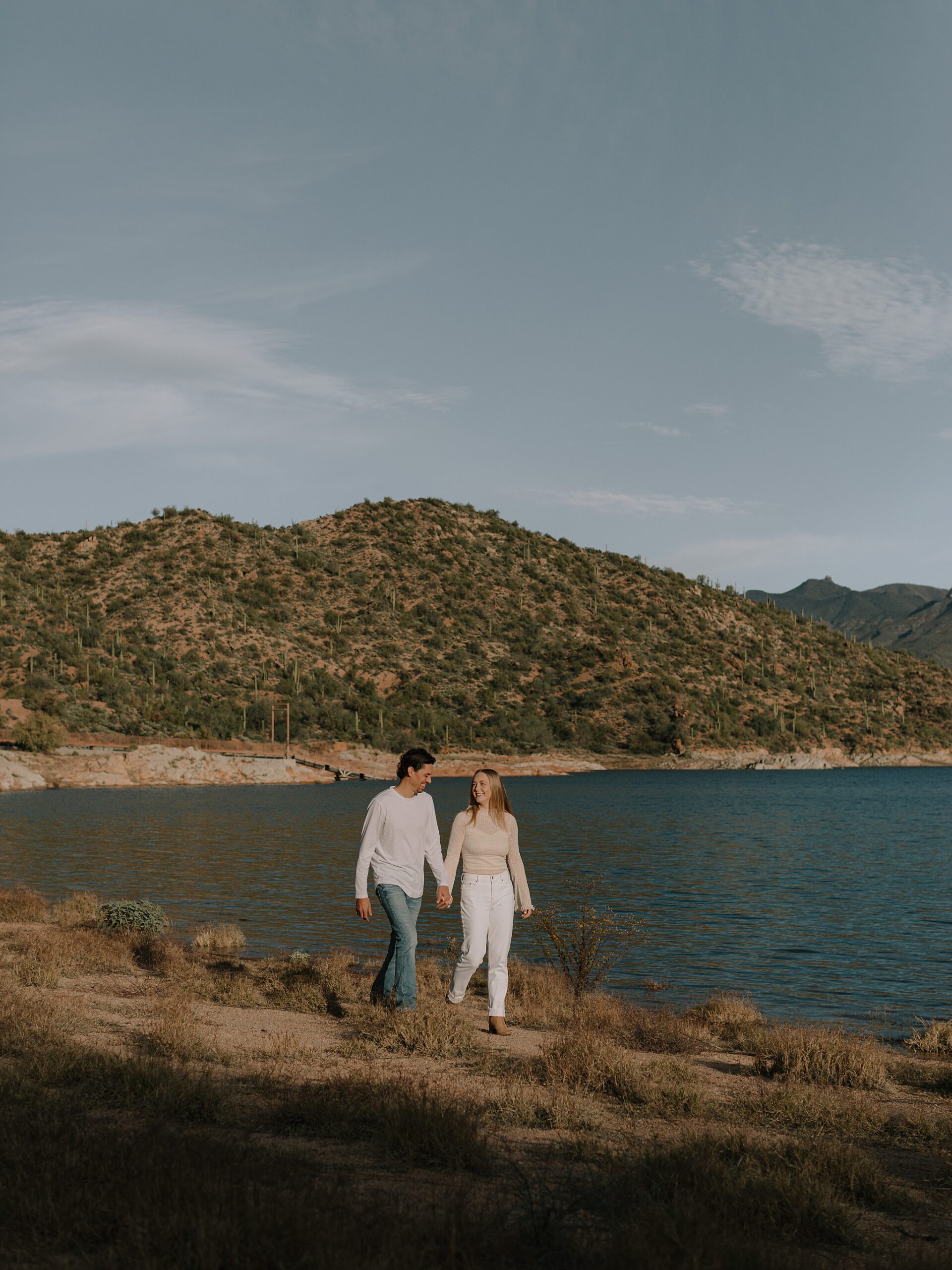 Couple walking by the water at Bartlett Lake