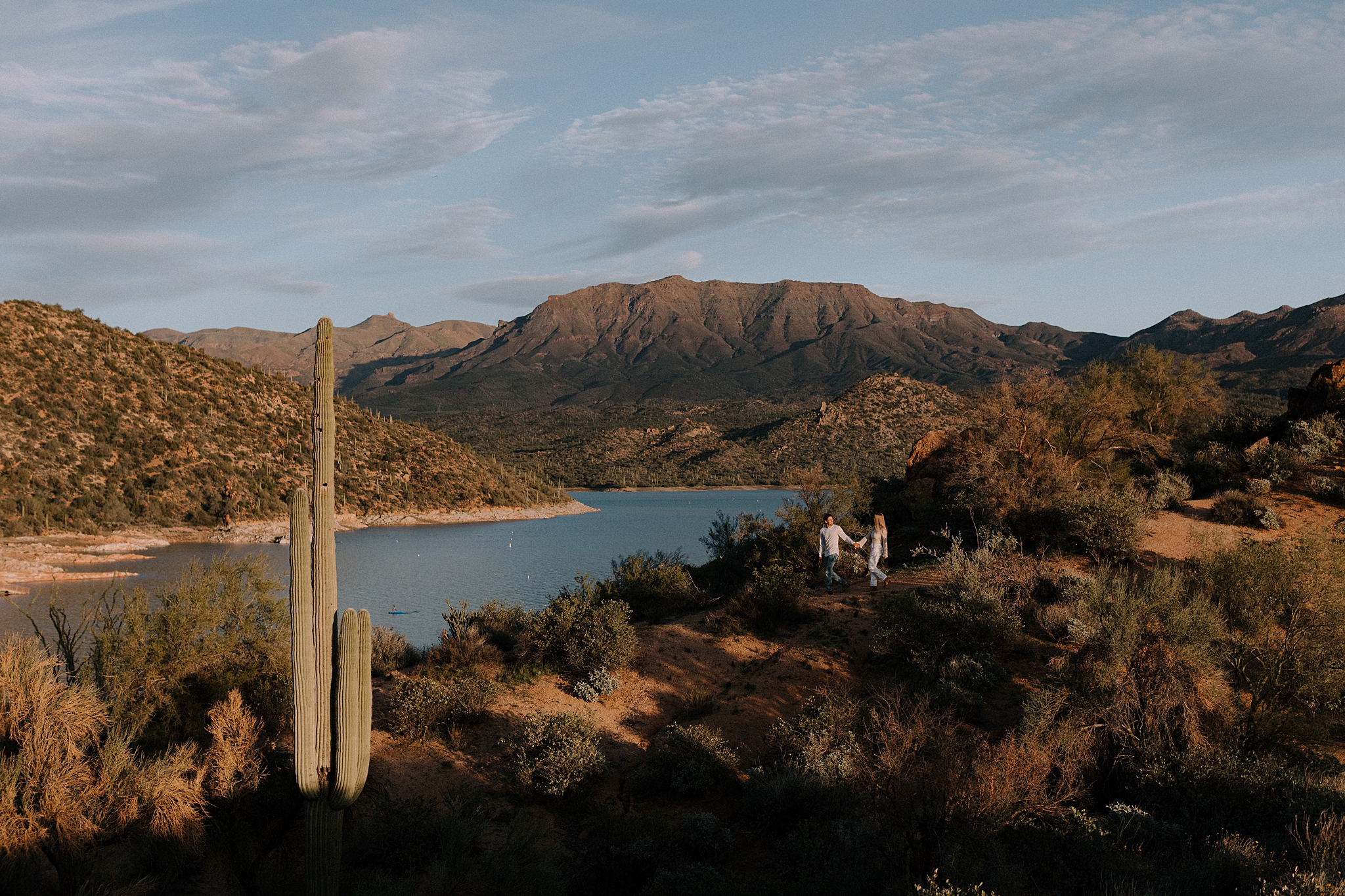 Couple at overlook with lake and mountains of Bartlett Lake