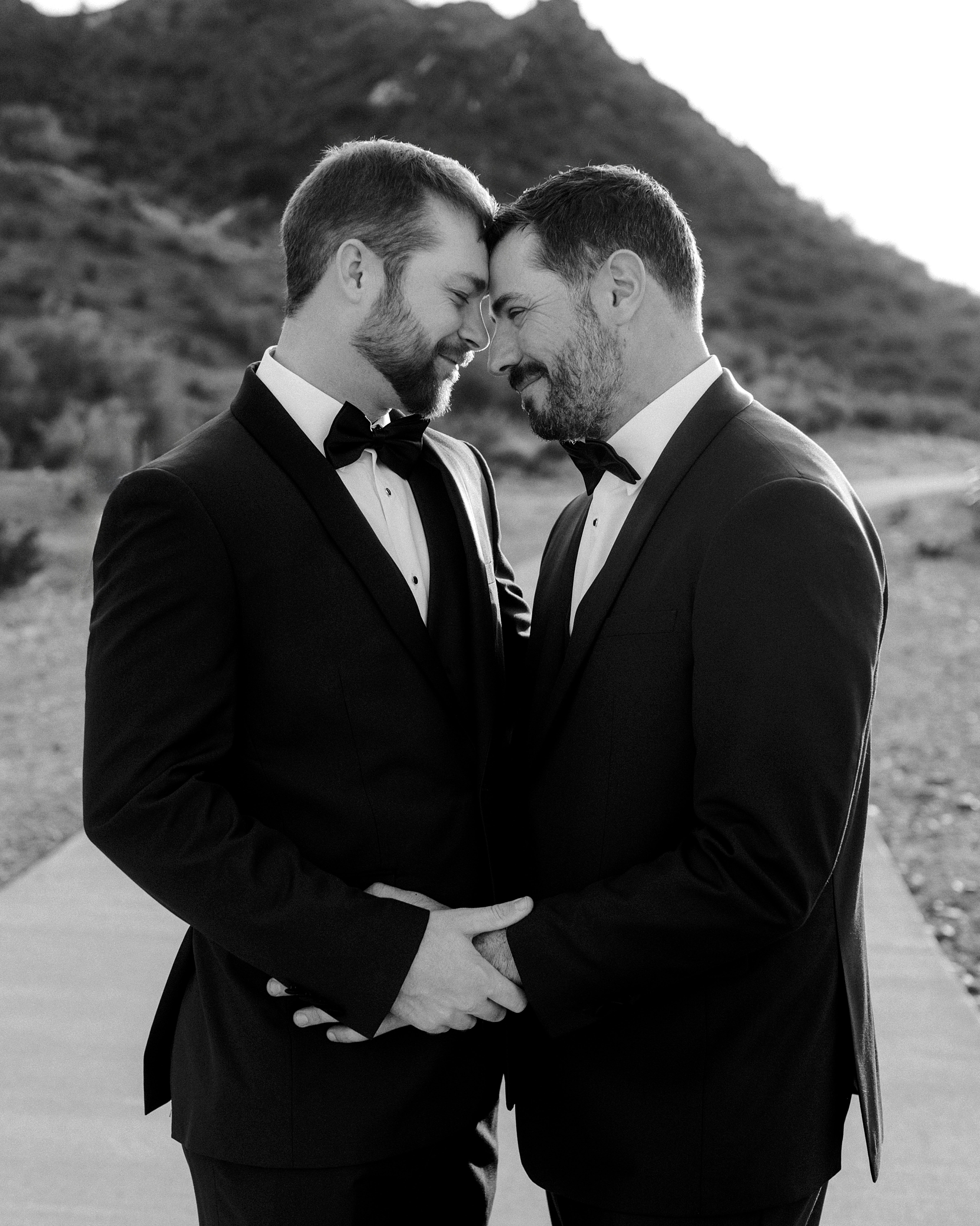 Intimate black and white portrait of two grooms before their wedding ceremony at Whitfill Nursery in Phoenix