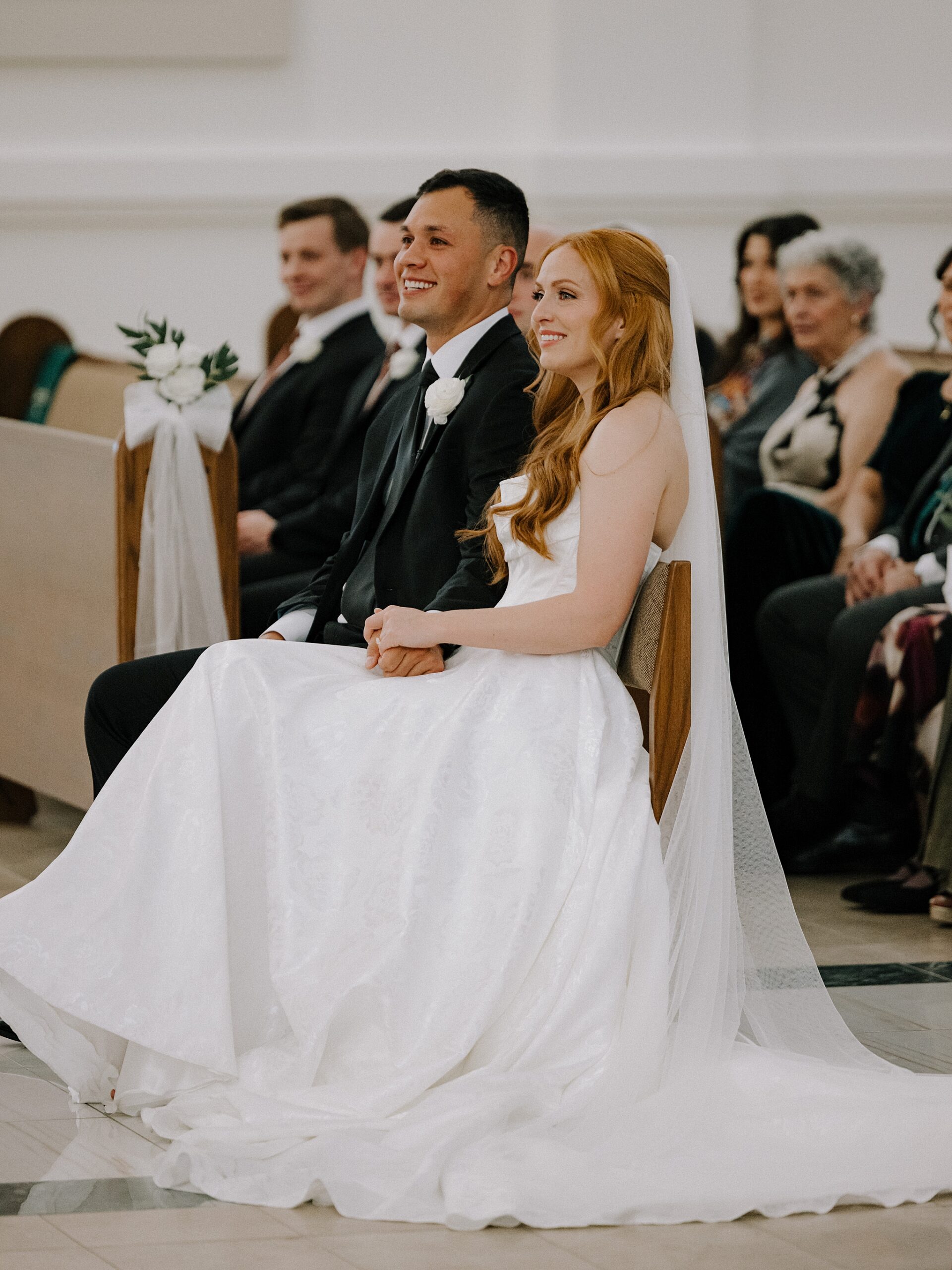 Bride and groom smiling at Saint Benedict Catholic Church Phoenix