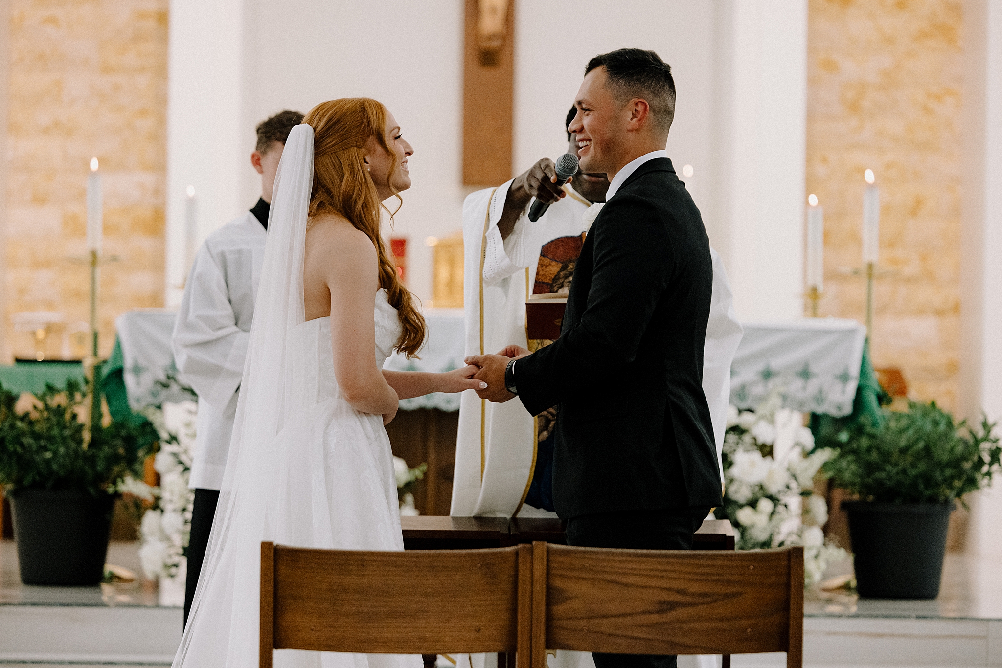 Bride and groom exchanging vows at Saint Benedict Catholic Church Phoenix