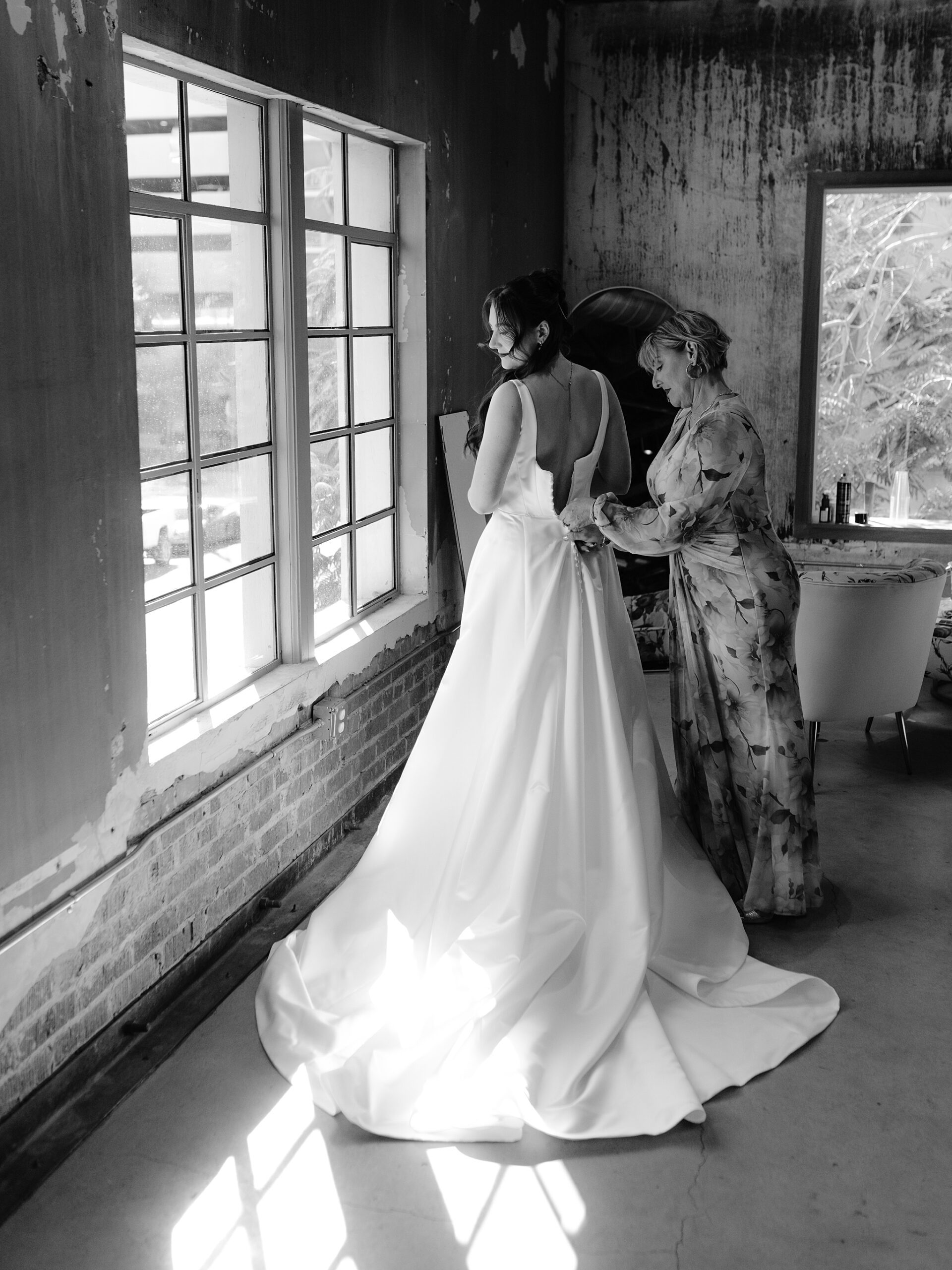 Bride putting on her wedding dress at the Monroe street abbey in Phoenix, Arizona
