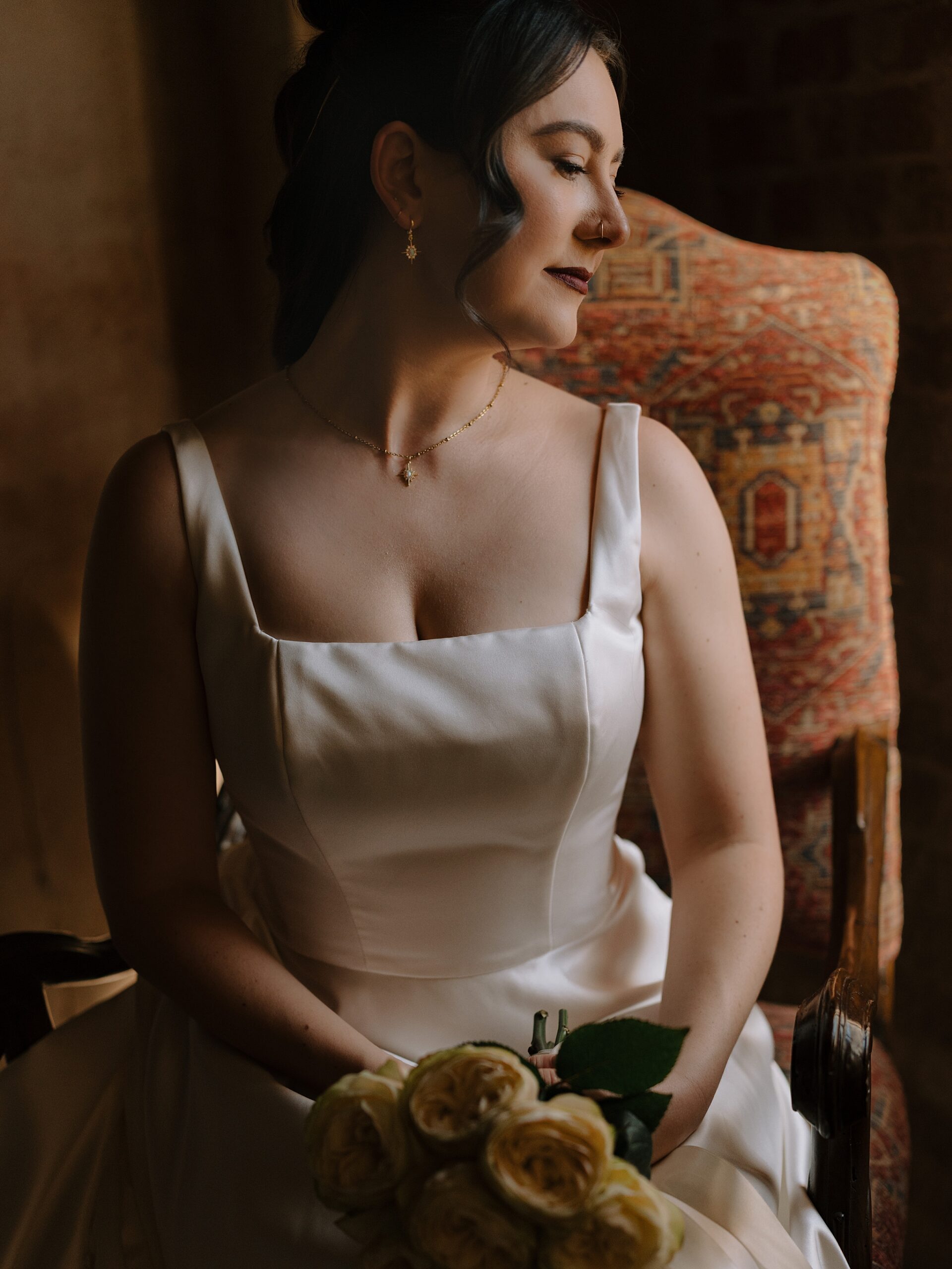 Bride sitting next to soft window light at the Monroe street abbey in Phoenix, Arizona