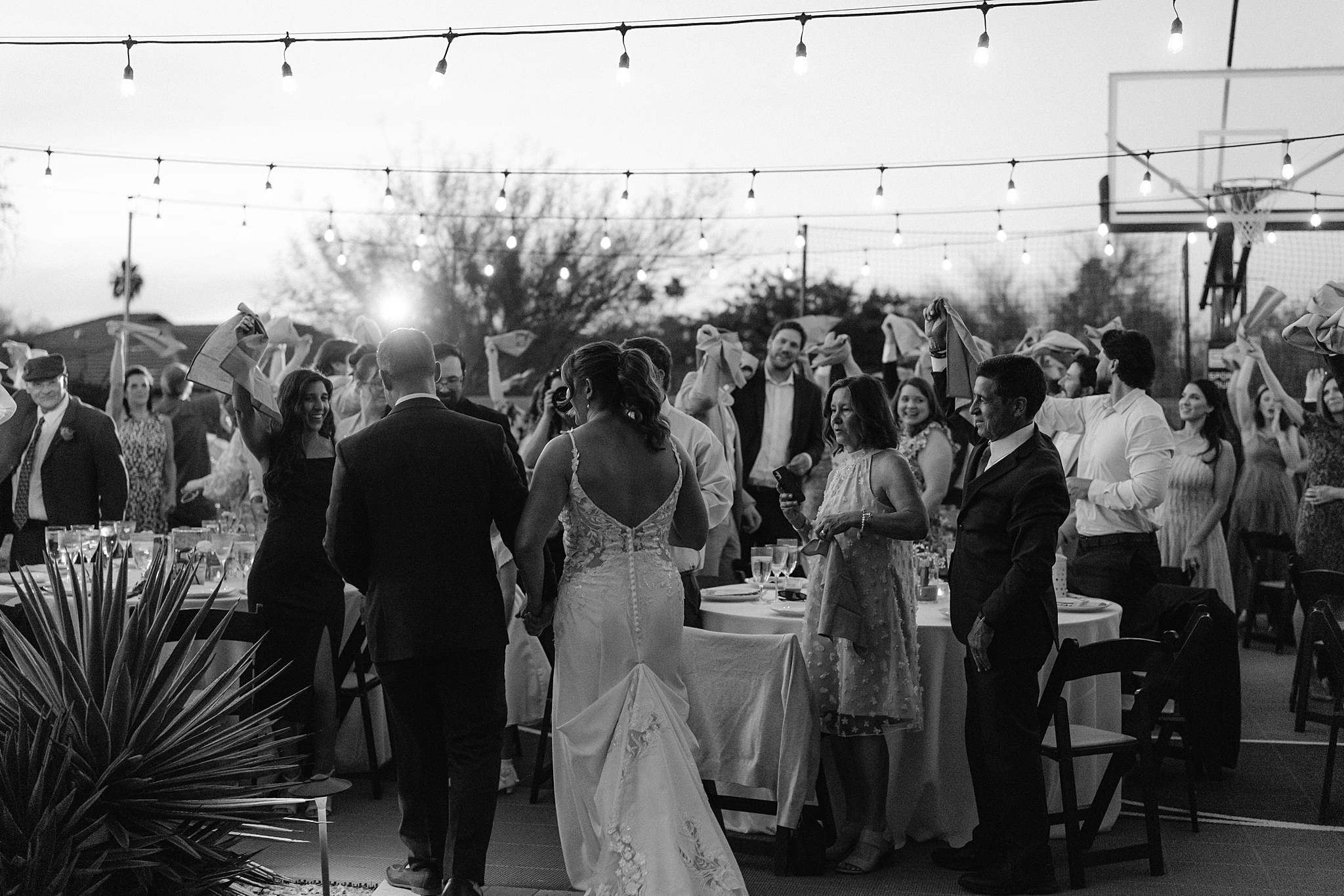 Wedding reception dinner on basketball court Phoenix backyard wedding