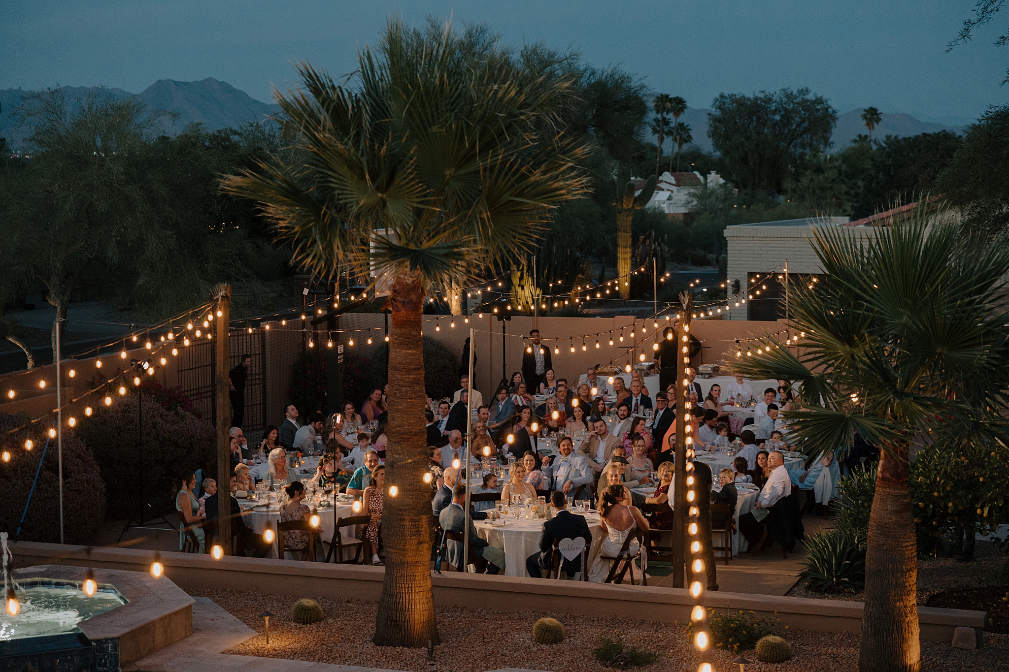 Wedding reception dinner on basketball court Phoenix backyard wedding