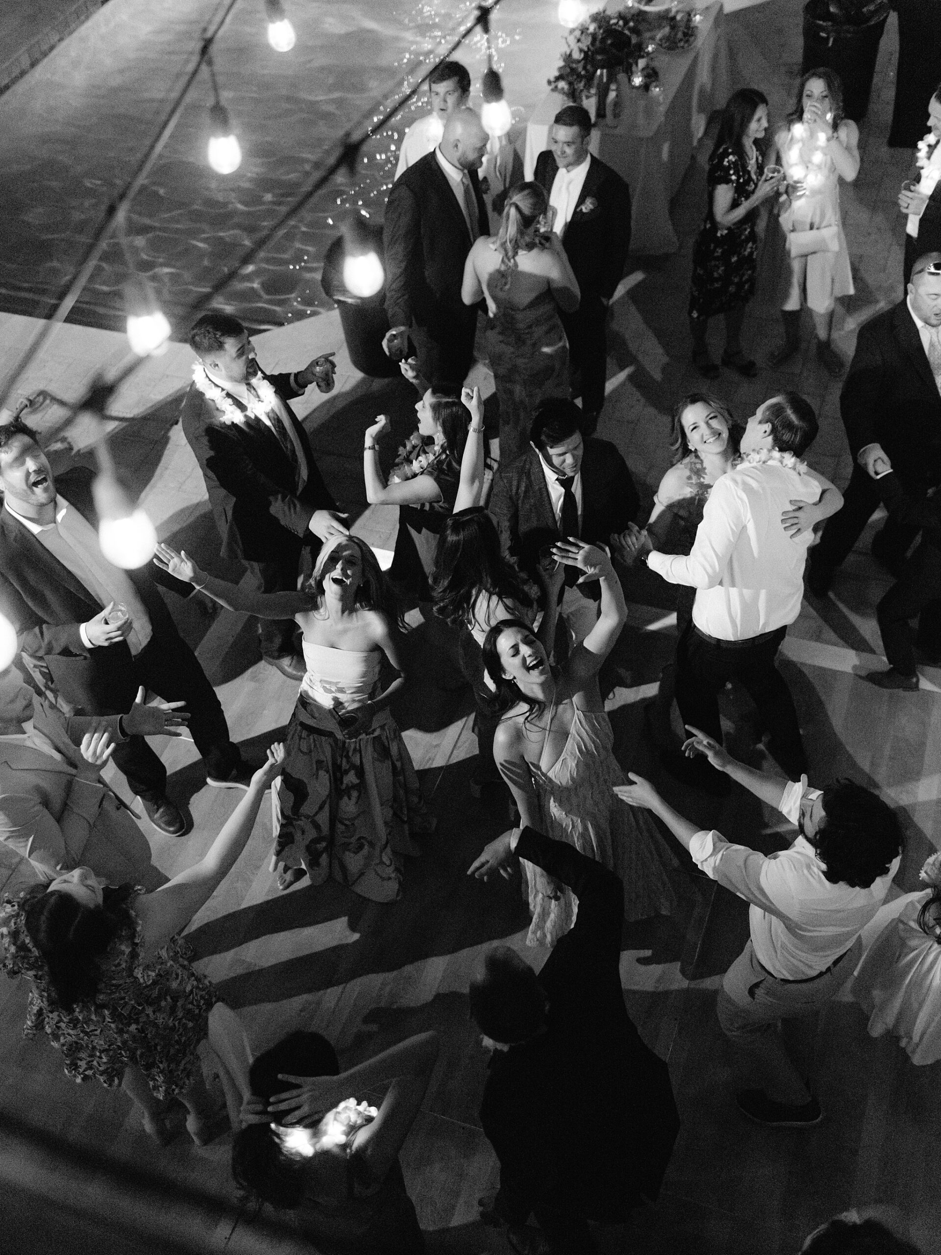 Dancing by the pool at backyard wedding reception Phoenix