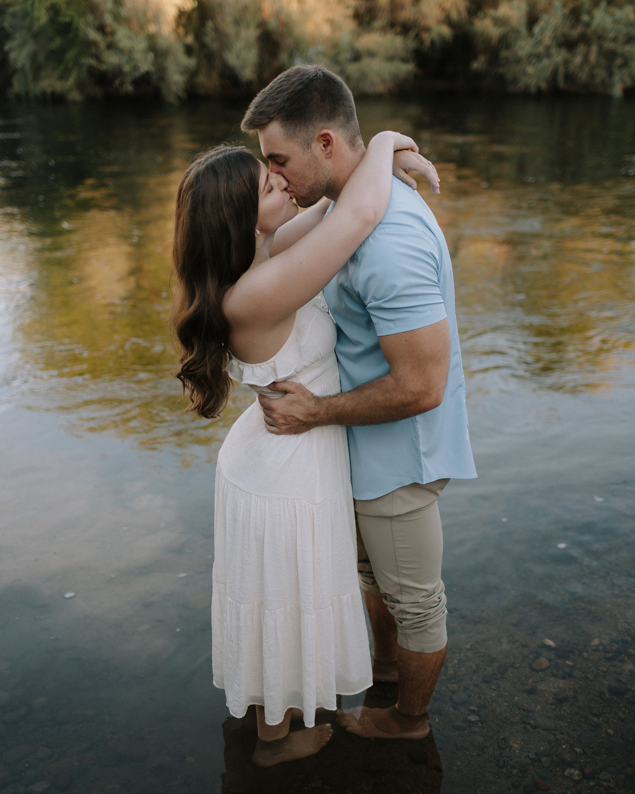 A engagement session in the Salt River, with the couple kissing