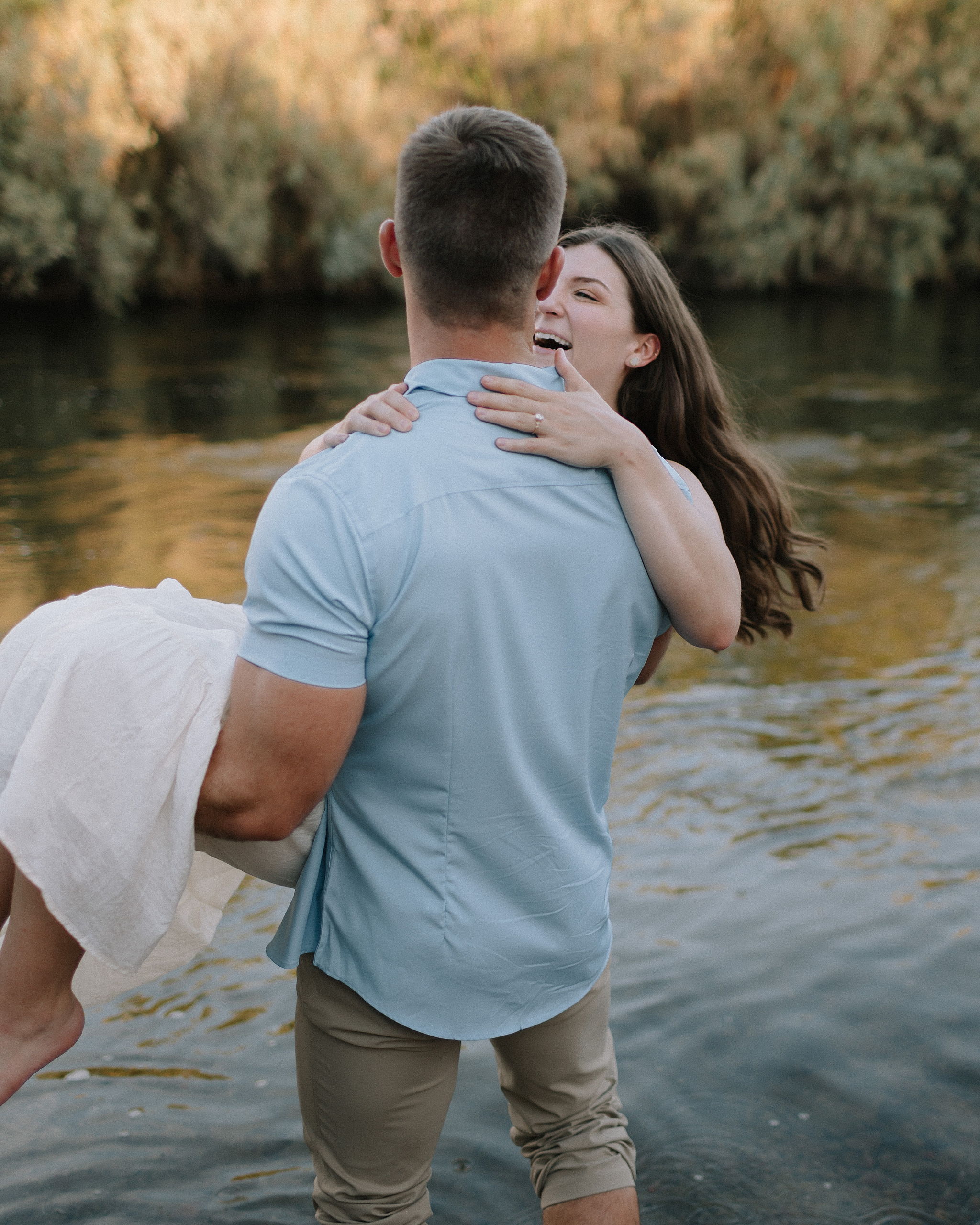 A engagement session in the Salt River, with the couple laughing