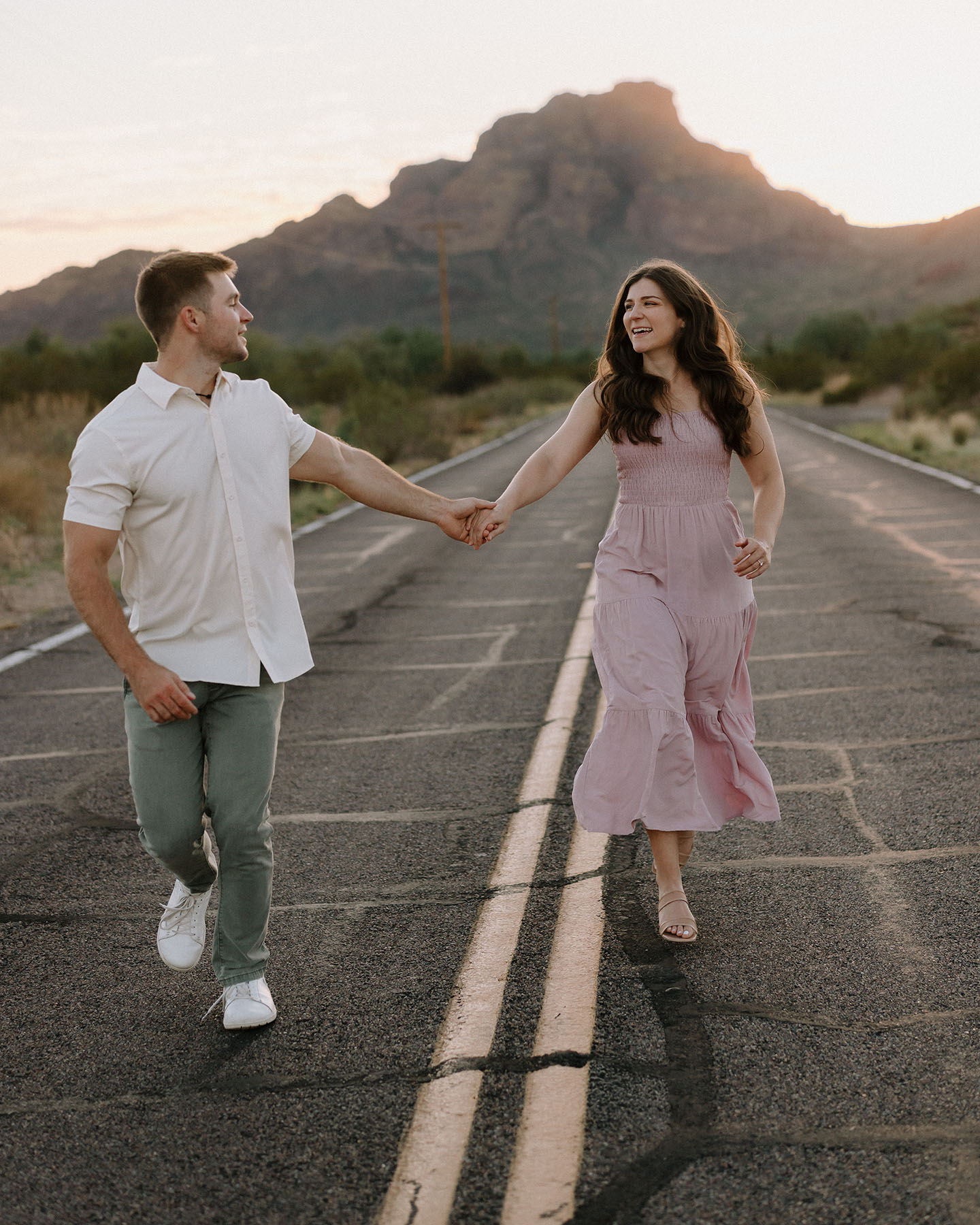 Couple running and laughing on the bush highway 